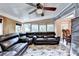 Spacious living room featuring a large sectional sofa, ceiling fan, and several bright windows at 4364 Saddlecreek Ct, Auburn, GA 30011