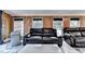 Living room with three windows, a sofa, and wood paneled walls, and a center table at 4364 Saddlecreek Ct, Auburn, GA 30011