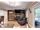 Living room with a stone fireplace and windows that provide natural light at 4364 Saddlecreek Ct, Auburn, GA 30011