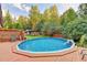 A private in-ground swimming pool surrounded by lush greenery creates a relaxing retreat at 4364 Saddlecreek Ct, Auburn, GA 30011