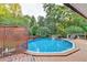A private in-ground swimming pool surrounded by lush greenery creates a relaxing retreat at 4364 Saddlecreek Ct, Auburn, GA 30011