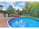 Inviting in-ground pool nestled in a serene backyard setting with wooded surroundings at 4364 Saddlecreek Ct, Auburn, GA 30011