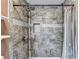 This walk-in shower features gray tile and a rainfall shower head at 4364 Saddlecreek Ct, Auburn, GA 30011