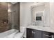 Modern bathroom features a tub, marble vanity, decorative mirror and tiled shower at 540 Woodall Ne Ave, Atlanta, GA 30306