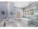 Bright bathroom featuring double sink vanity with marble countertop, modern tub, and a glass shower at 540 Woodall Ne Ave, Atlanta, GA 30306