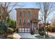Brick home featuring a two-car garage, small front porch, and multiple stories at 540 Woodall Ne Ave, Atlanta, GA 30306
