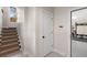 Hallway view with tiled floors, stairs, door to backyard, and an entrance to the garage gym at 540 Woodall Ne Ave, Atlanta, GA 30306