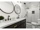 Modern bathroom with double sinks, stylish fixtures, and a beautifully tiled walk-in shower at 2392 Jefferson Ter, Atlanta, GA 30344