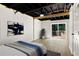 Bedroom showcasing an exposed ceiling, light hardwood floors, and a sliding door that offers backyard access at 2392 Jefferson Ter, Atlanta, GA 30344