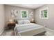 Cozy bedroom with soft lighting, neutral tones, and windows overlooking a peaceful outdoor view at 2392 Jefferson Ter, Atlanta, GA 30344