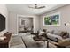 Inviting living room featuring contemporary furniture, a ceiling fan, and large windows at 2392 Jefferson Ter, Atlanta, GA 30344