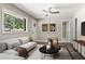 Bright living room with modern furnishings, stylish decor, and a large window overlooking a wooded area at 2392 Jefferson Ter, Atlanta, GA 30344