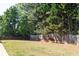 Spacious backyard featuring mature trees and a wood privacy fence at 310 Morning Glen Dr, Suwanee, GA 30024