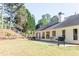 Large backyard featuring a built-in patio, outdoor dining area, and a grill at 310 Morning Glen Dr, Suwanee, GA 30024