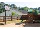 Large backyard with a playset and a basketball goal at 310 Morning Glen Dr, Suwanee, GA 30024