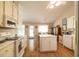 Open kitchen with white appliances, a center island, and an attached breakfast nook at 310 Morning Glen Dr, Suwanee, GA 30024