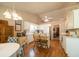 Well-lit kitchen with white cabinetry, a center island, and an adjacent dining area at 310 Morning Glen Dr, Suwanee, GA 30024