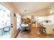 Eat-in kitchen with white cabinets, a view of the backyard, and an adjacent dining area at 310 Morning Glen Dr, Suwanee, GA 30024