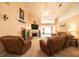 Inviting living room with a cozy fireplace, plush seating, a ceiling fan, and abundant natural light at 310 Morning Glen Dr, Suwanee, GA 30024