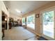 Bright sun room with a view of the backyard, filled with bookshelves and cozy seating at 310 Morning Glen Dr, Suwanee, GA 30024