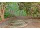 Backyard landscape showcasing stone steps leading into the wooded area at 3958 Windgrove Xing, Suwanee, GA 30024