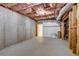 Unfinished basement features concrete walls, open ceiling, and a doorway to a finished area at 3958 Windgrove Xing, Suwanee, GA 30024