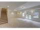 Finished basement with plush carpeting, recessed lighting, staircase and walk-out doors at 3958 Windgrove Xing, Suwanee, GA 30024