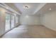 Finished basement with carpet, recessed lighting, and glass doors leading to the exterior at 3958 Windgrove Xing, Suwanee, GA 30024
