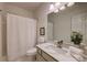 Bright bathroom features vanity with white marble top, a shower and tub combination and a toilet at 3958 Windgrove Xing, Suwanee, GA 30024
