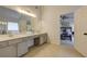 Bright bathroom with double vanity sinks and a doorway leading to a bedroom at 3958 Windgrove Xing, Suwanee, GA 30024