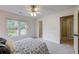 Cozy bedroom features soft carpet, double windows with natural light, and convenient access to other rooms at 3958 Windgrove Xing, Suwanee, GA 30024