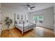 Bright bedroom features wood floors, ceiling fan, two windows and neutral decor at 3958 Windgrove Xing, Suwanee, GA 30024