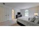 The bedroom showcases a minimalist design, featuring an arched window for natural light and soft carpeted floors at 3958 Windgrove Xing, Suwanee, GA 30024