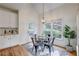 Bright breakfast nook with table and chairs, chandelier lighting, large windows, and a door leading to the deck at 3958 Windgrove Xing, Suwanee, GA 30024