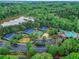 Aerial view of community amenities including sports courts, a playground, pond and parking area at 3958 Windgrove Xing, Suwanee, GA 30024