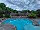 A large in-ground community pool with deck chairs and well-manicured landscaping surrounds the pool house at 3958 Windgrove Xing, Suwanee, GA 30024