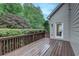 Spacious outdoor deck with access to the home and views of mature landscaping at 3958 Windgrove Xing, Suwanee, GA 30024