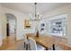 Dining area with contemporary chandelier and views into the living room at 3958 Windgrove Xing, Suwanee, GA 30024
