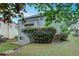Two-story house with backyard patio, manicured lawn, and lush trees at 3958 Windgrove Xing, Suwanee, GA 30024