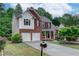 Charming two-story brick home featuring a two-car garage, front porch, and landscaped front yard at 3958 Windgrove Xing, Suwanee, GA 30024