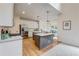 Kitchen with stainless steel appliances, white cabinets, hardwood floors, granite countertops, and an adjacent eat-in kitchen at 3958 Windgrove Xing, Suwanee, GA 30024