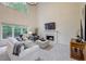 Bright living room with fireplace, tall ceilings, and large windows at 3958 Windgrove Xing, Suwanee, GA 30024