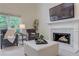 Comfortable living room with fireplace, large windows, and neutral decor at 3958 Windgrove Xing, Suwanee, GA 30024