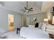Bright and airy Primary bedroom features a tray ceiling, neutral paint, fan, and bathroom access at 3958 Windgrove Xing, Suwanee, GA 30024