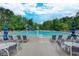 Large community pool with ample seating, a slide, and beautiful landscaping for a resort-like experience at 3958 Windgrove Xing, Suwanee, GA 30024