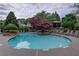 Tranquil community pool surrounded by lush landscaping, offering a serene recreational space at 3958 Windgrove Xing, Suwanee, GA 30024