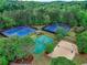 Aerial view of well-maintained tennis and sand volleyball courts surrounded by green landscaping at 3958 Windgrove Xing, Suwanee, GA 30024