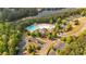 Aerial view of a community pool, clubhouse, parking lot and a small pond at 409 Retreat Ln, Canton, GA 30114
