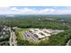 Expansive aerial view showcasing the school, surrounding trees and mountains in the distance at 409 Retreat Ln, Canton, GA 30114