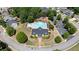 Aerial view of community pool, clubhouse, playground, manicured landscaping and ample parking in a desirable neighborhood at 409 Retreat Ln, Canton, GA 30114
